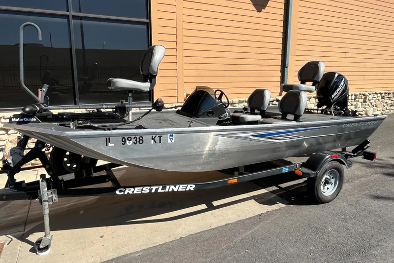 Slide: The Image of 2016 Crestliner 1600 Storm fishing boat on trailer, parked outdoors. - 0