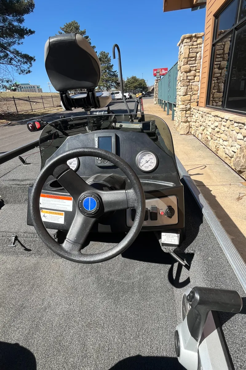 Slide: The Image of 2016 Crestliner 1600 Storm boat interior with steering wheel and dashboard controls. - 1