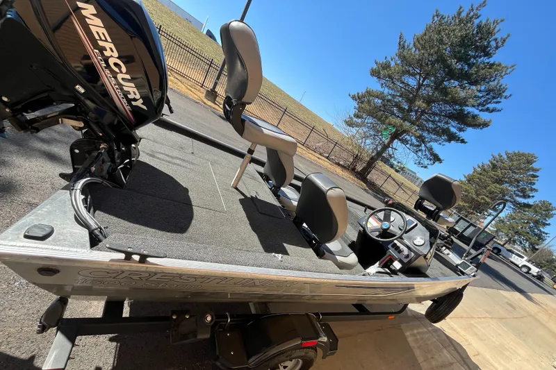 Slide: The Image of 2016 Crestliner 1600 Storm boat with Mercury engine, parked outdoors on a sunny day. - 3