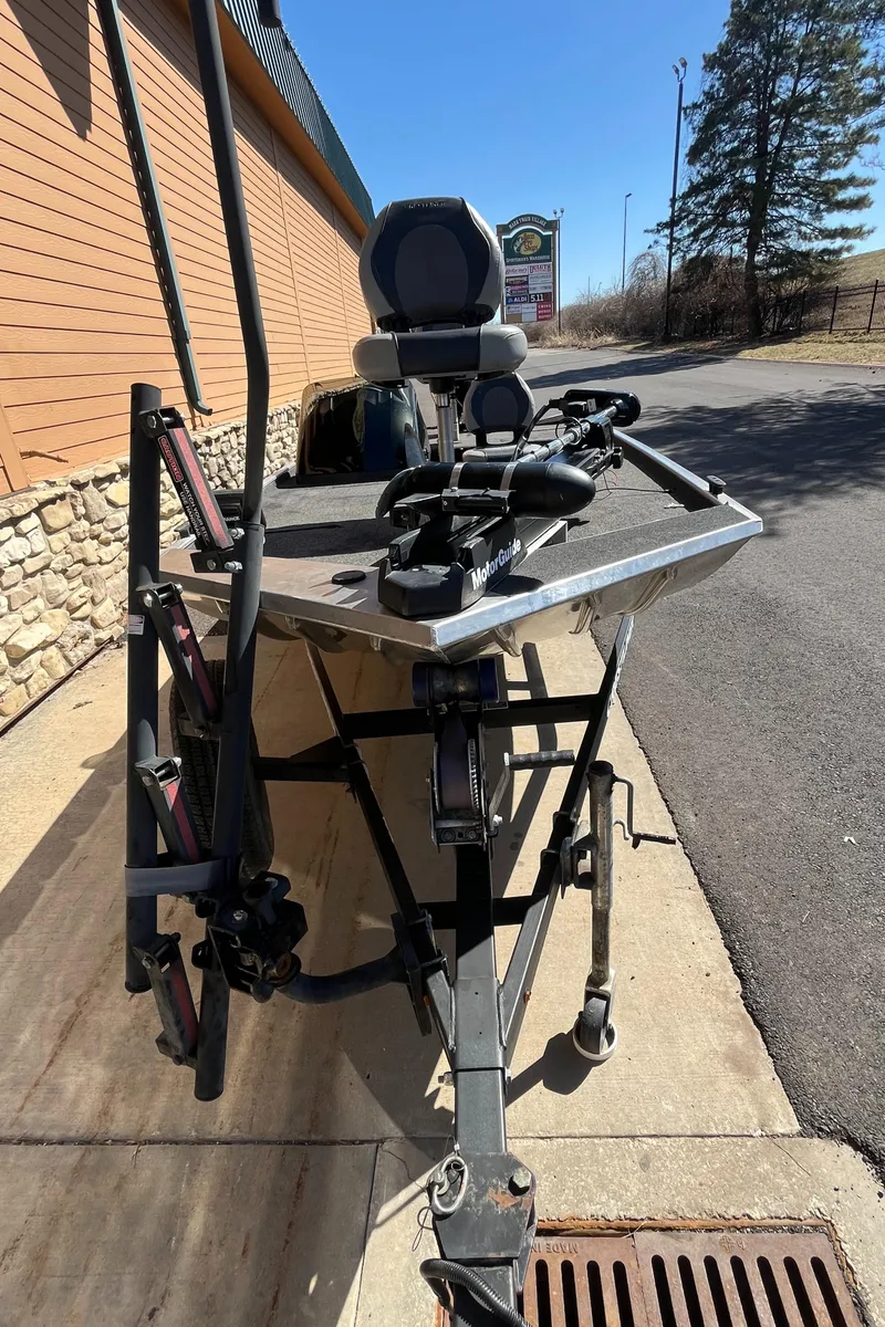 Slide: The Image of 2016 Crestliner 1600 Storm boat on trailer, parked outdoors near a building. - 6