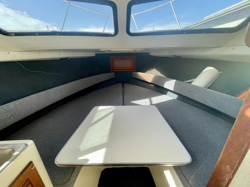 Slide: The Image of Interior of 1993 Skipjack 263 Fisherman boat with table and seating. - 11