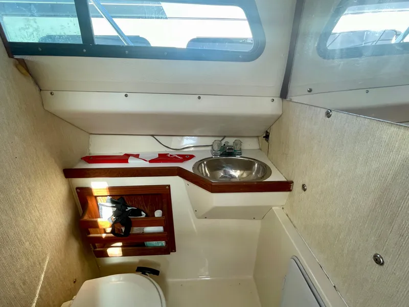 Slide: The Image of Interior of 1993 Skipjack 263 Fisherman boat with sink and storage shelves. - 16
