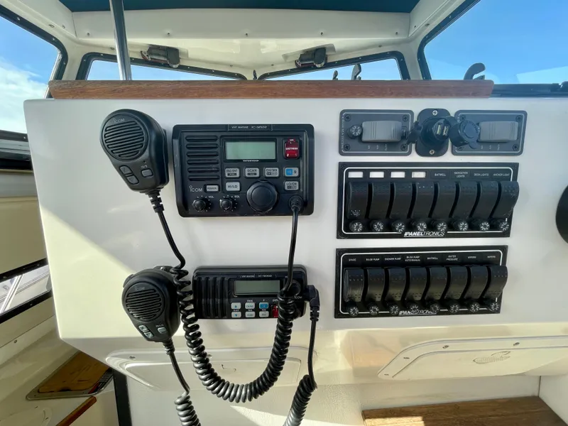 Slide: The Image of Control panel of a 1993 Skipjack 263 Fisherman boat with radios and switches. - 18