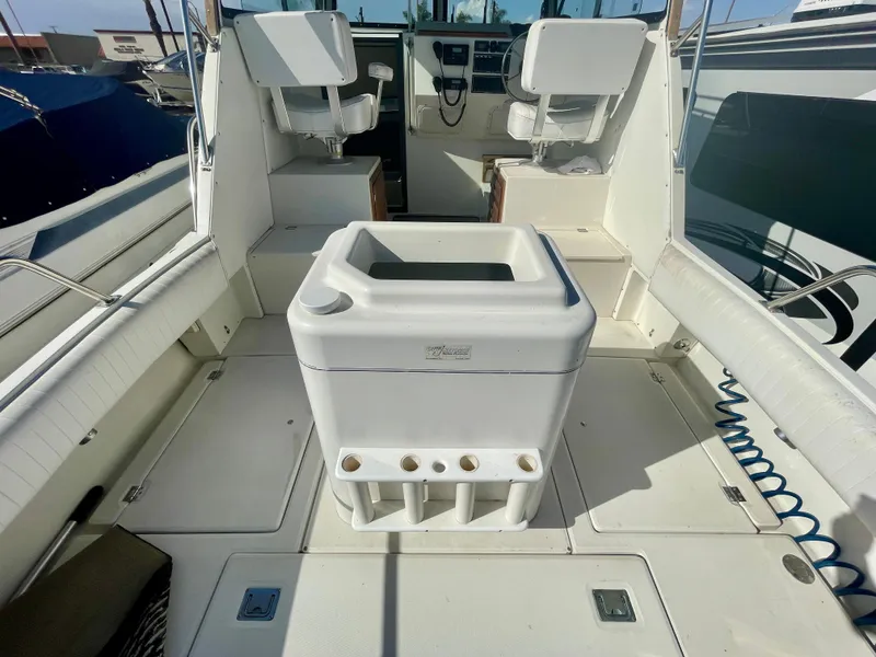 Slide: The Image of 1993 Skipjack 263 Fisherman boat interior with seating and storage compartments. - 23