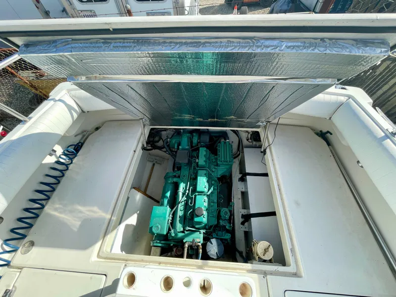 Slide: The Image of Engine compartment of a 1993 Skipjack 263 Fisherman boat, showcasing the engine and interior details. - 26