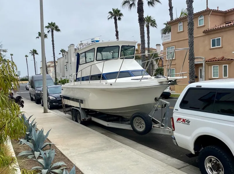 Slide: The Image of 1993 Skipjack 263 Fisherman boat on trailer, parked on a residential street. - 5