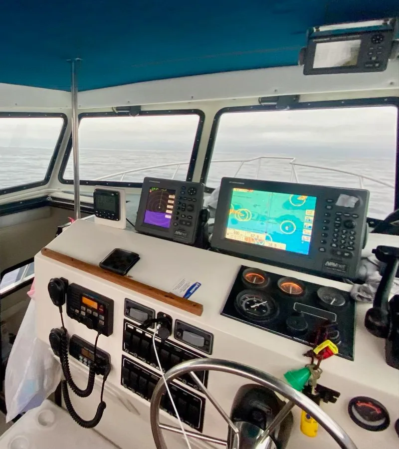 Slide: The Image of Interior of 1993 Skipjack 263 Fisherman boat with navigation equipment and steering wheel. - 6