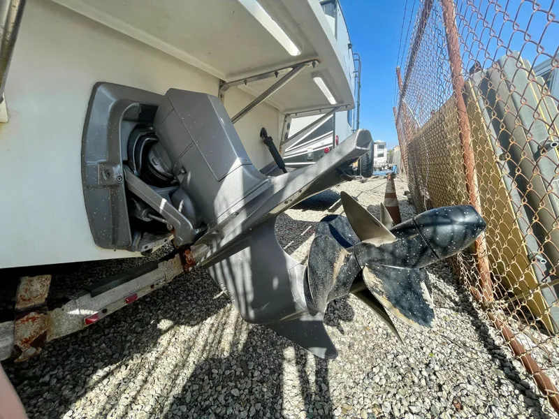 Slide: The Image of 1993 Skipjack 263 Fisherman boat propeller and stern drive on gravel. - 8