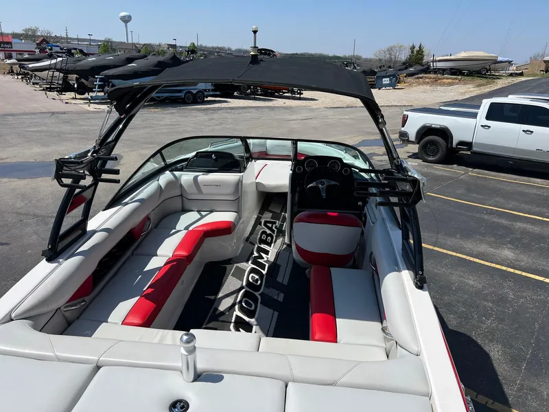 Slide: The Image of 2013 Moomba Mojo 2.5 boat with red and white interior, parked in a lot. - 10