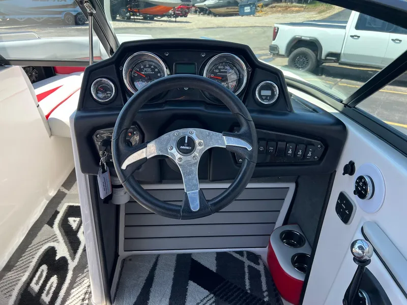 Slide: The Image of 2013 Moomba Mojo 2.5 boat dashboard with steering wheel and gauges. - 14