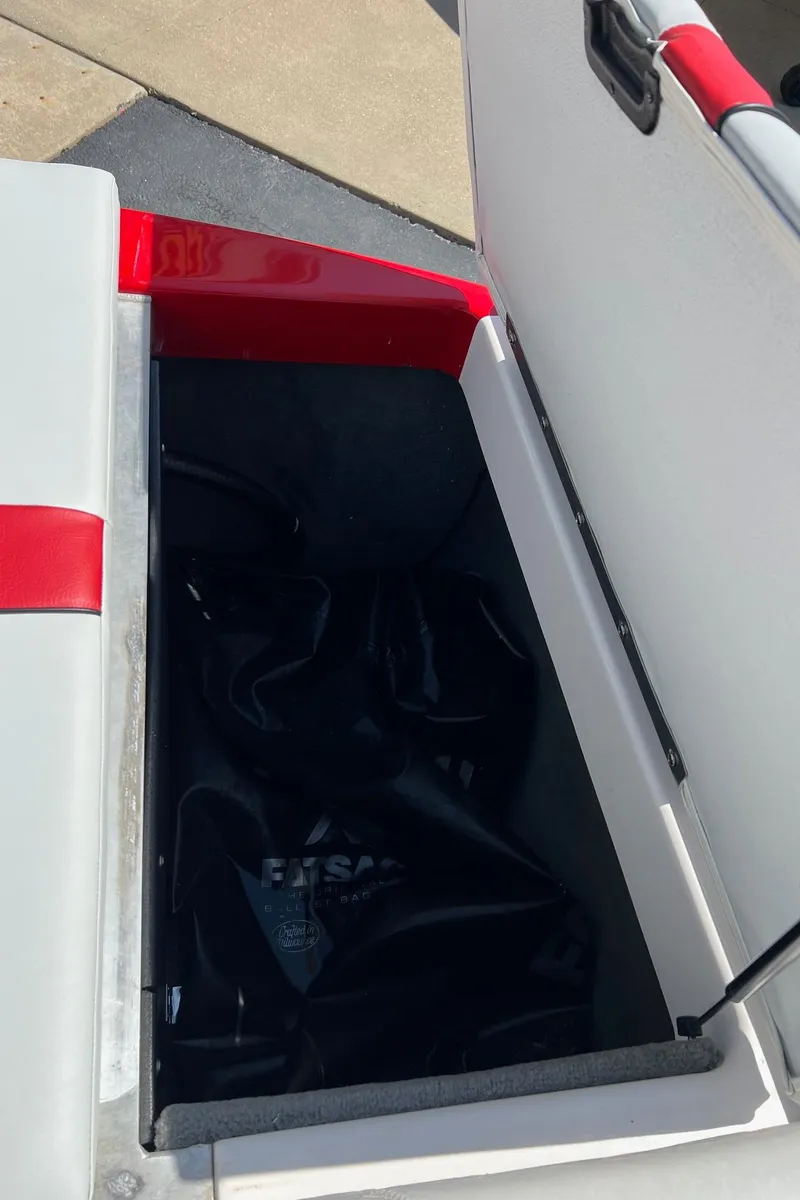 Slide: The Image of 2013 Moomba Mojo 2.5 boat storage compartment with red and white interior. - 18