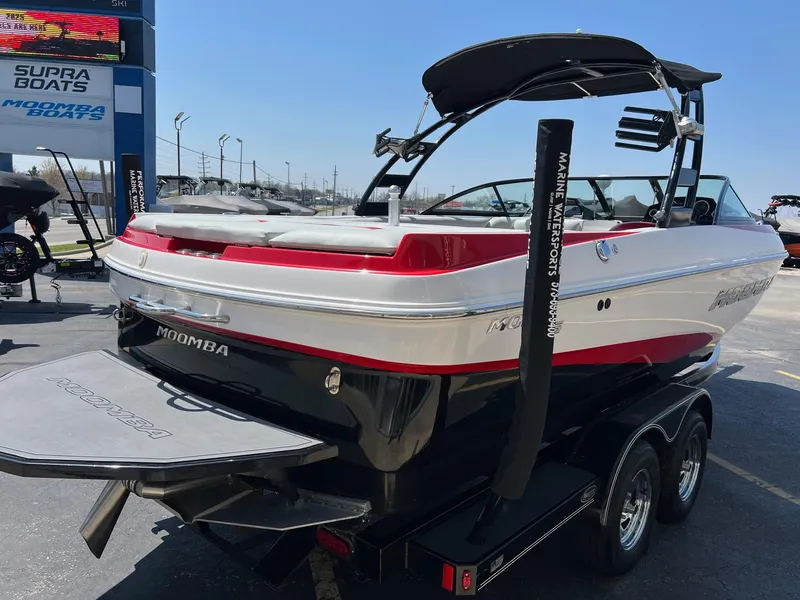 Slide: The Image of 2013 Moomba Mojo 2.5 boat with red and white design on a trailer. - 7