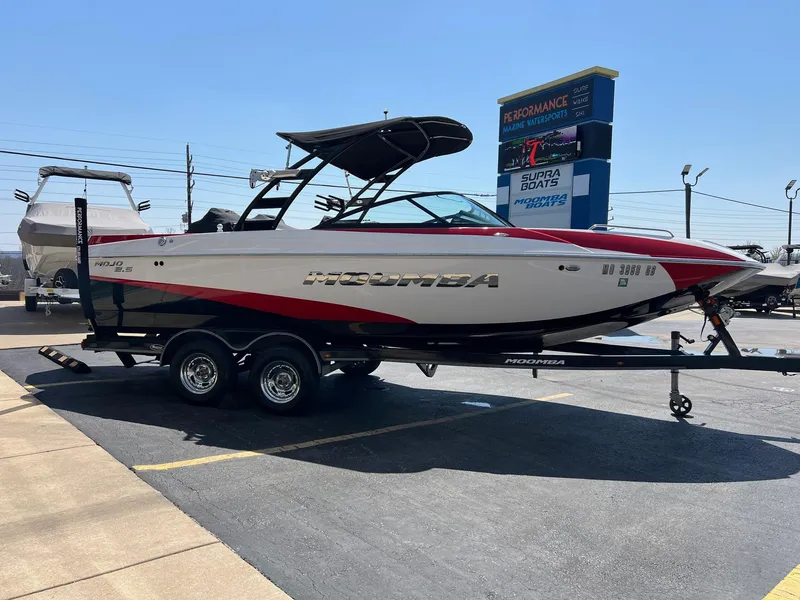 Slide: The Image of 2013 Moomba Mojo 2.5 boat on trailer, parked outdoors at a dealership. - 8