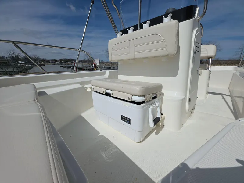 Slide: The Image of 2024 Boston Whaler 150 Montauk interior with seating and storage. - 13