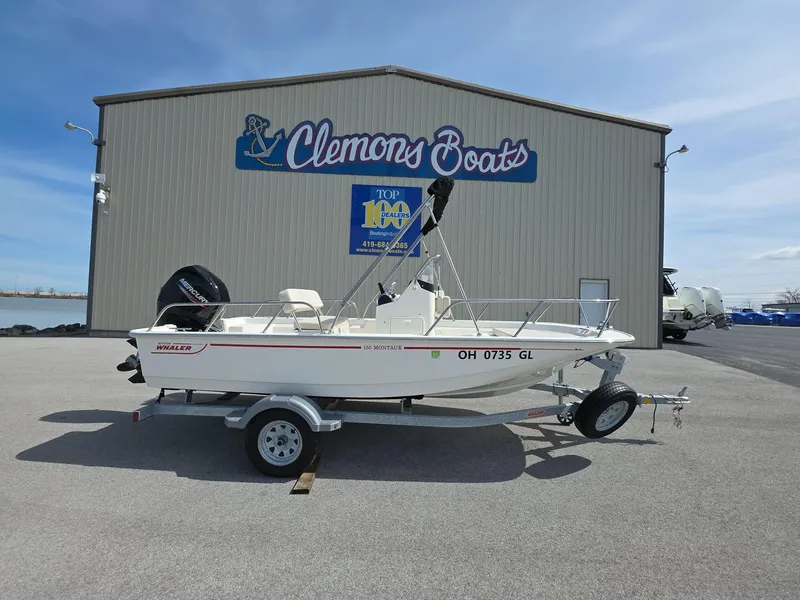Slide: The Image of 2024 Boston Whaler 150 Montauk boat on trailer at Clemons Boats dealership. - 2