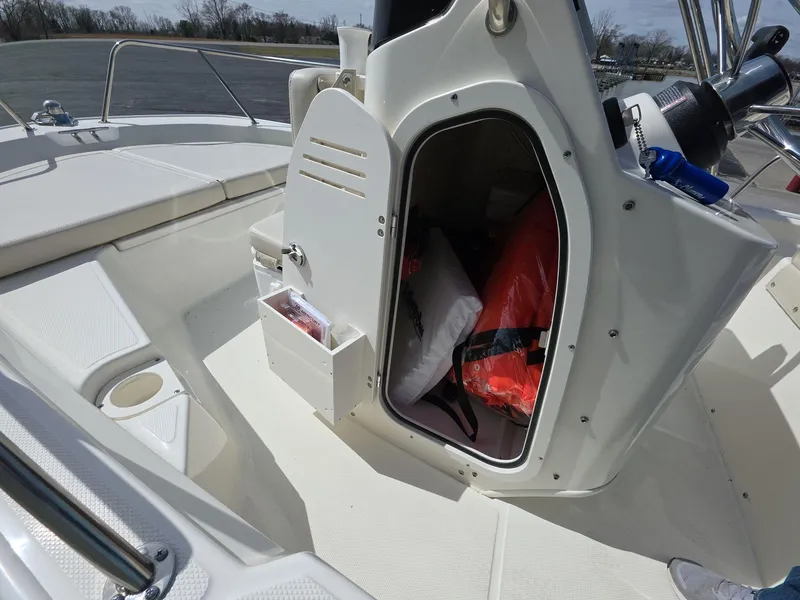 Slide: The Image of 2024 Boston Whaler 150 Montauk boat interior with open storage compartment. - 9