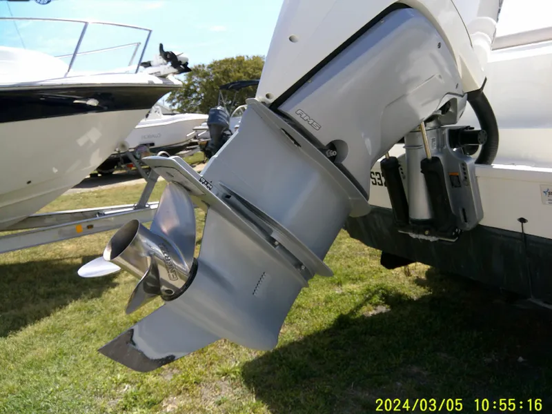 Slide: The Image of Outboard motor of a 2021 Boston Whaler Outrage 230, displayed on grass. - 10