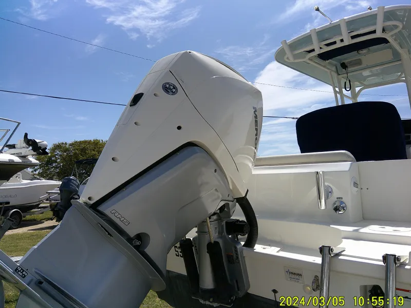 Slide: The Image of Boston Whaler Outrage 230 boat, 2021 model, with powerful outboard motor, under clear blue sky. - 11
