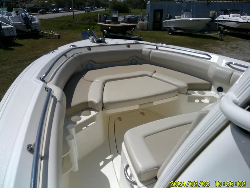Slide: The Image of 2021 Boston Whaler Outrage 230 boat interior with cushioned seating. - 14