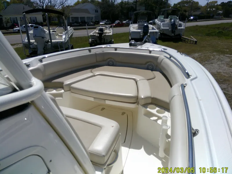 Slide: The Image of 2021 Boston Whaler Outrage 230 boat interior with cushioned seating and cup holders. - 15