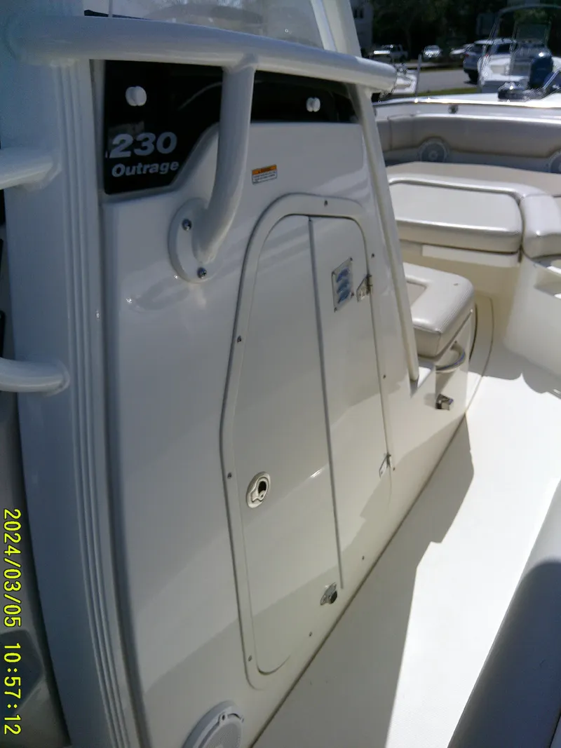 Slide: The Image of Boston Whaler Outrage 230, 2021 model, interior view with seating and storage. - 23
