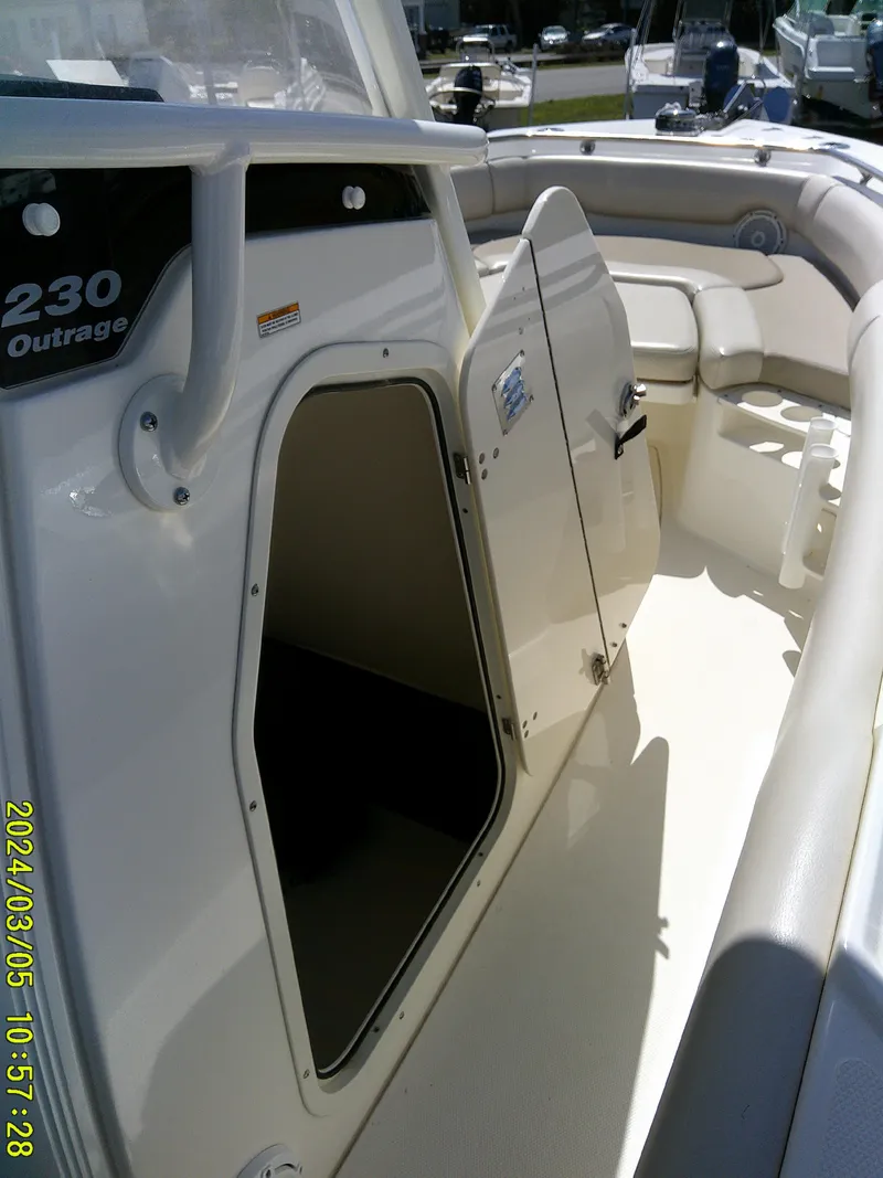 Slide: The Image of 2021 Boston Whaler Outrage 230 boat interior with open storage compartment. - 24
