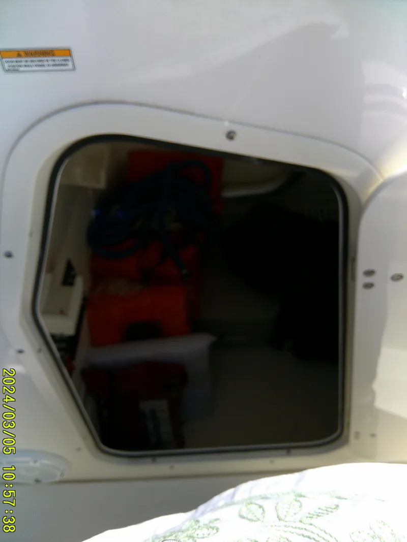 Slide: The Image of Storage compartment on a 2021 Boston Whaler Outrage 230 boat. - 25