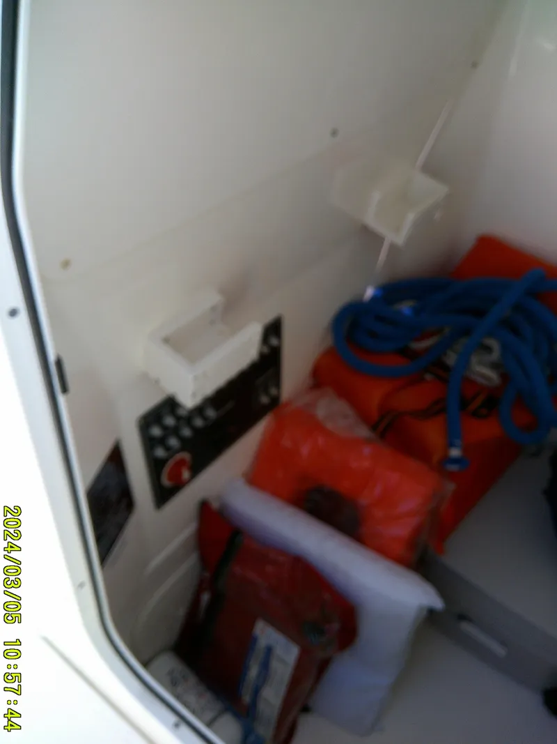 Slide: The Image of Interior of a 2021 Boston Whaler Outrage 230 with safety equipment and control panel. - 26