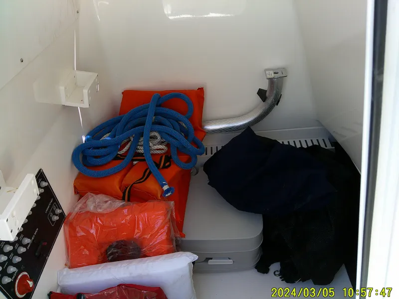 Slide: The Image of Interior storage of 2021 Boston Whaler Outrage 230 with ropes and life jackets. - 27