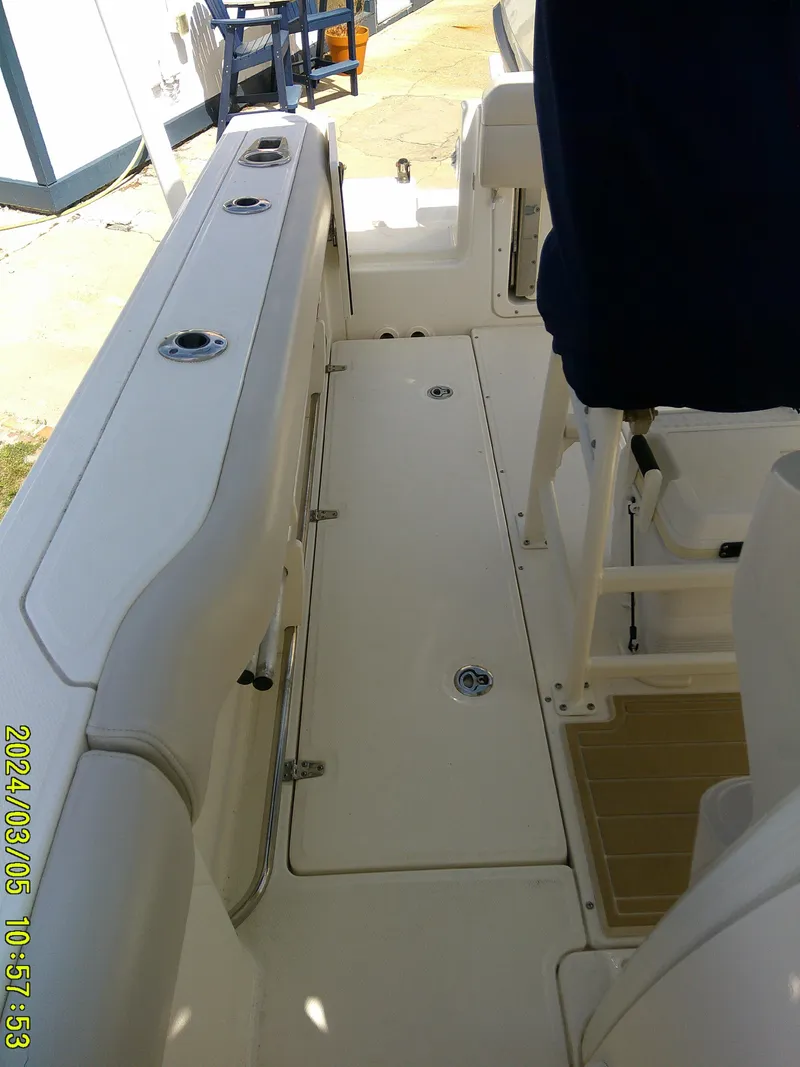 Slide: The Image of 2021 Boston Whaler Outrage 230 boat interior, featuring seating and deck layout. - 28