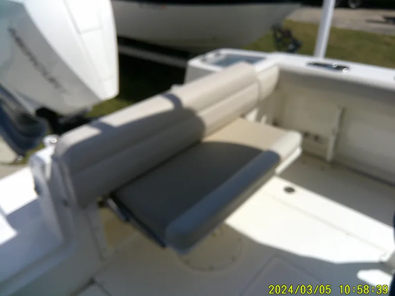 Slide: The Image of 2021 Boston Whaler Outrage 230 boat interior with cushioned seating. - 33