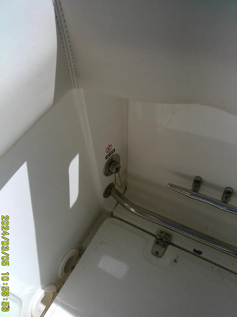 Slide: The Image of Interior view of a 2021 Boston Whaler Outrage 230 boat, showing metal fixtures. - 35