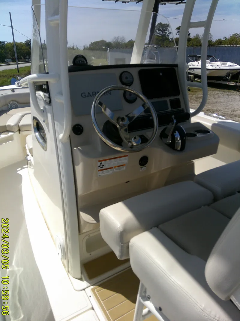 Slide: The Image of 2021 Boston Whaler Outrage 230 boat cockpit with steering wheel and seating. - 39