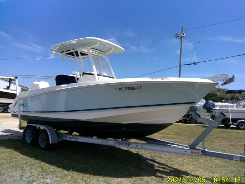 Slide: The Image of 2021 Boston Whaler Outrage 230 boat on trailer under clear blue sky. - 4