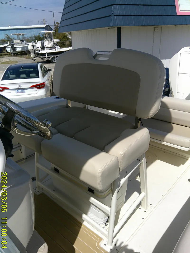 Slide: The Image of 2021 Boston Whaler Outrage 230 boat seating, beige upholstery, outdoor setting. - 40