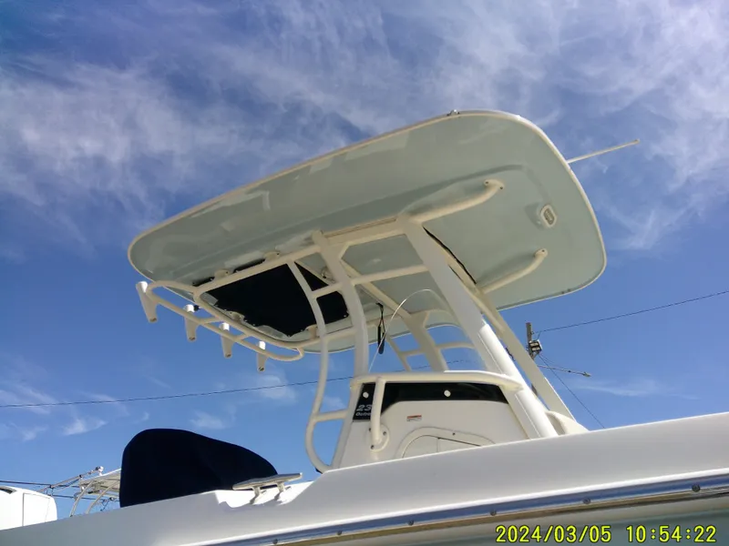 Slide: The Image of 2021 Boston Whaler Outrage 230 boat against a clear blue sky. - 5