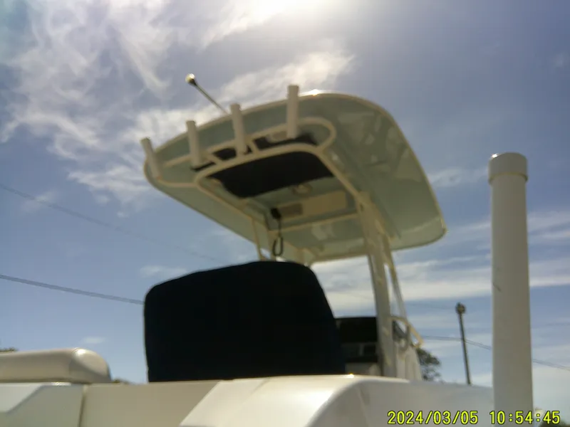Slide: The Image of Boston Whaler Outrage 230 boat, 2021 model, under a clear blue sky. - 8