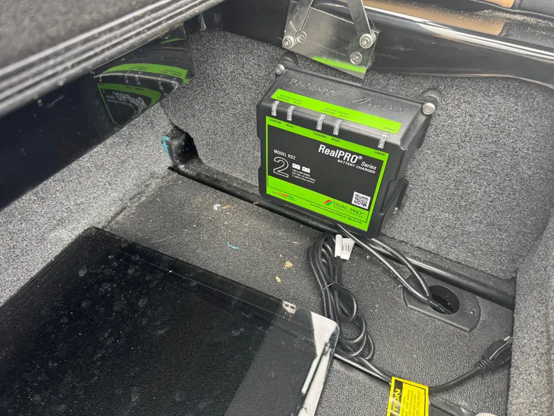 Slide: The Image of 2022 Moomba Makai battery compartment with RealPRO charger installed. - 11