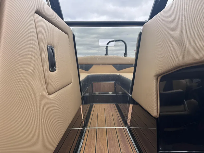 Slide: The Image of 2022 Moomba Makai interior with tan upholstery and wood flooring, showcasing luxury design. - 12