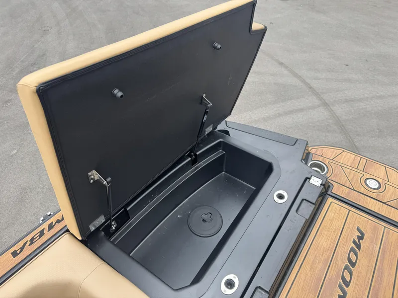 Slide: The Image of Open storage compartment on 2022 Moomba Makai boat, featuring tan and black design. - 13