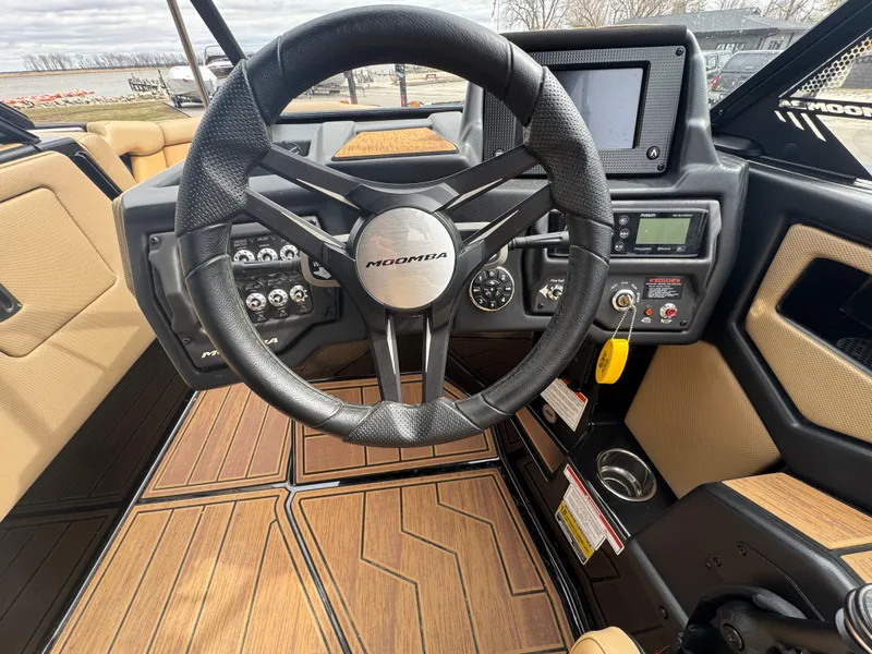 Slide: The Image of 2022 Moomba Makai boat interior with steering wheel and dashboard controls. - 18