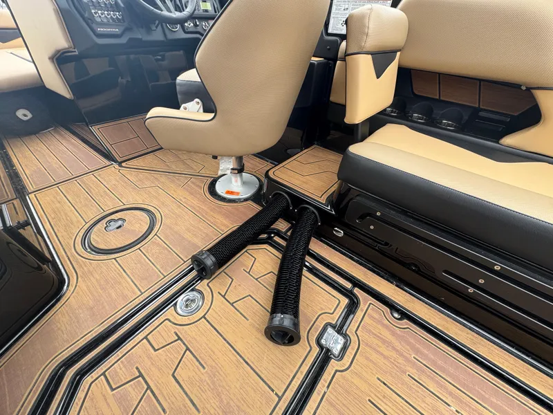 Slide: The Image of 2022 Moomba Makai interior with tan seats and wood-patterned flooring. - 19