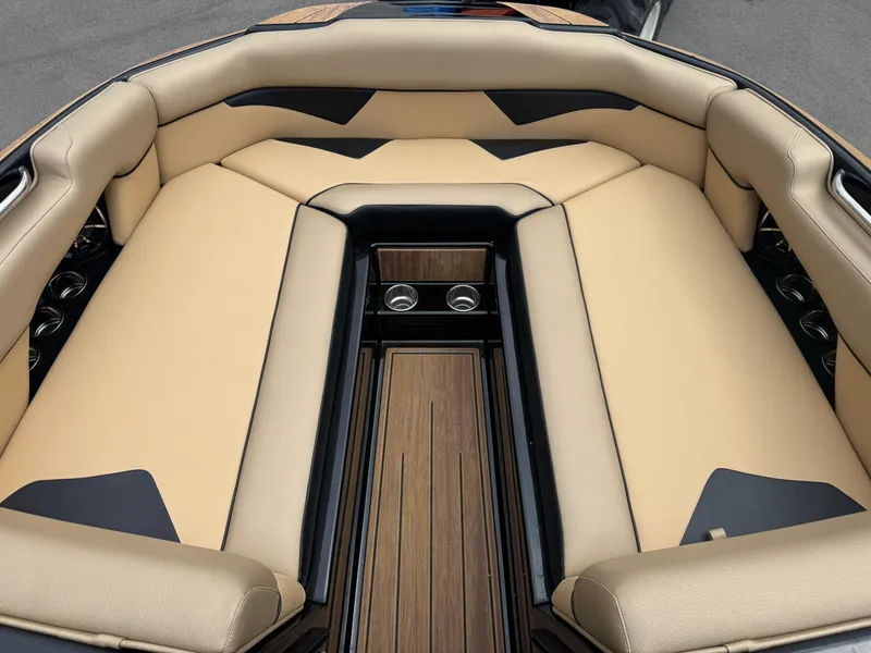 Slide: The Image of 2022 Moomba Makai boat interior with beige seating and wood accents. - 26