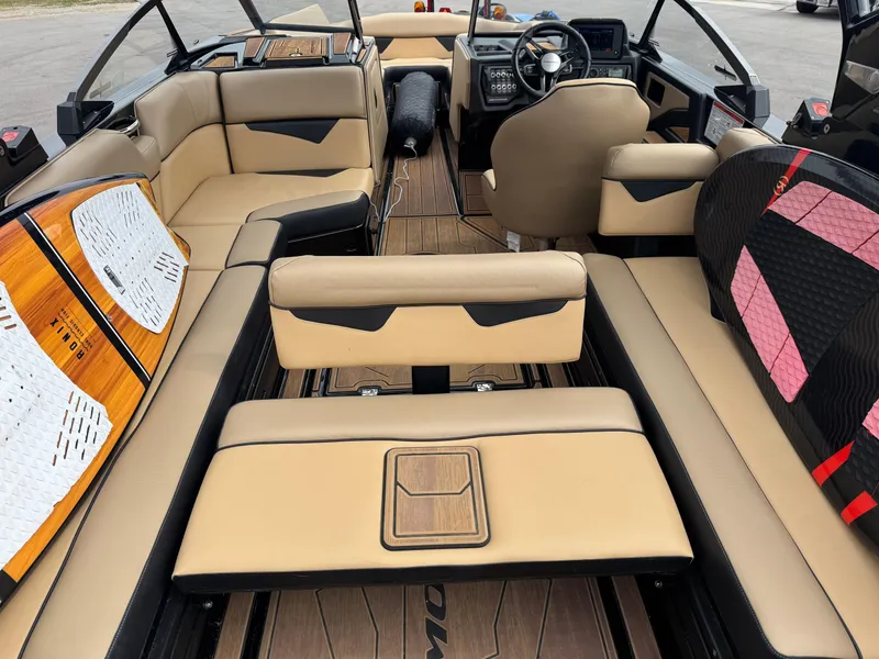 Slide: The Image of 2022 Moomba Makai boat interior with beige seating and modern dashboard design. - 29