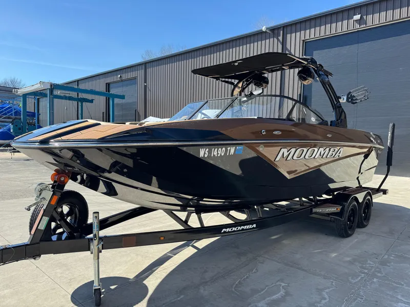 Slide: The Image of 2022 Moomba Makai boat on trailer, parked outdoors near a warehouse. - 3