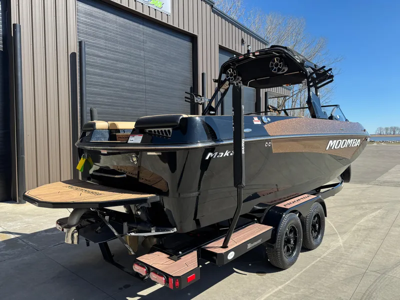 Slide: The Image of 2022 Moomba Makai boat on trailer, parked outside a building. - 7