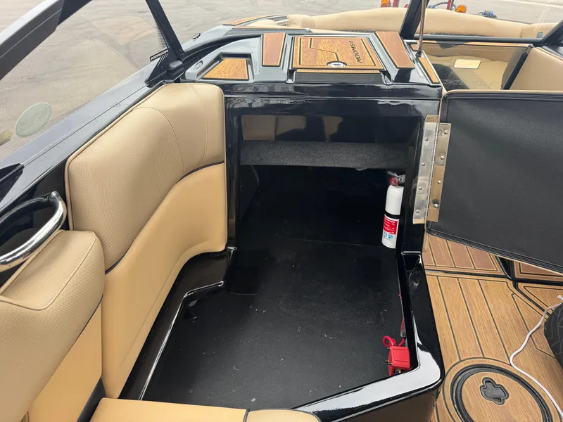 Slide: The Image of 2022 Moomba Makai boat interior with tan seating and storage area. - 8