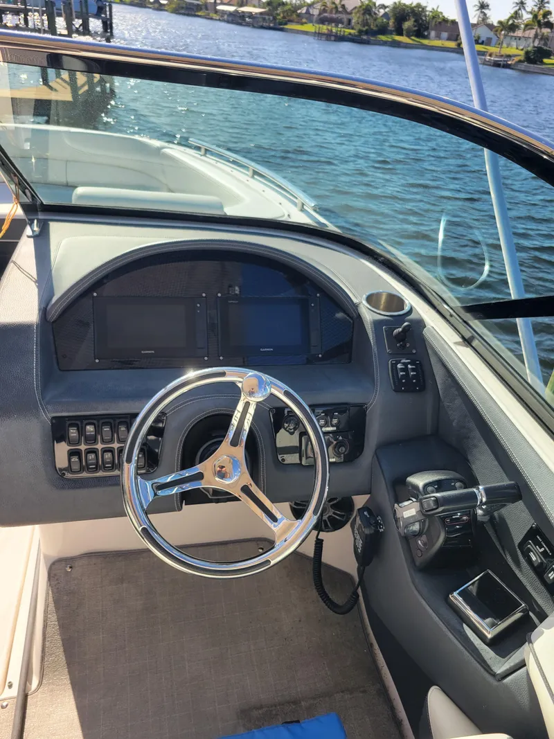 Slide: The Image of 2020 Regal 29 OBX boat cockpit with steering wheel and control panel. - 9