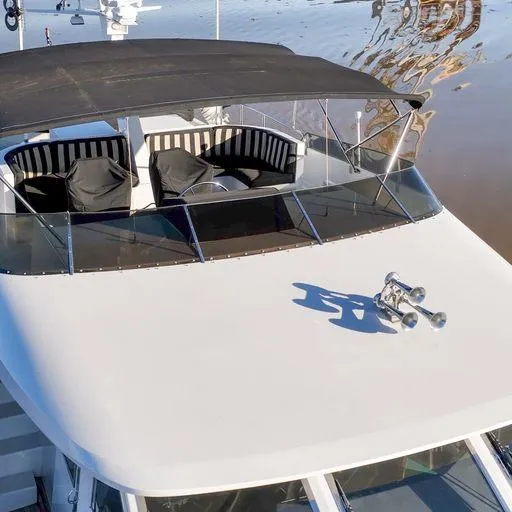 Slide: The Image of 1991 Vic Franck 65 Motor Yacht with covered seating area on deck. - 13