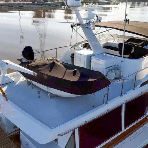 Slide: The Image of 1991 Vic Franck 65 Motor Yacht deck with covered dinghy and seating area. - 14